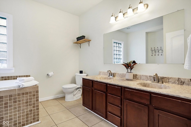 full bath with tile patterned flooring, double vanity, toilet, and a sink