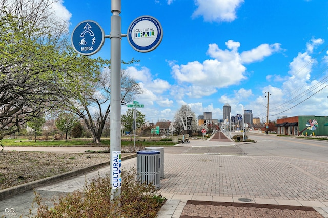 view of street featuring a city view and curbs