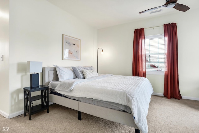 bedroom featuring light carpet, visible vents, ceiling fan, and baseboards