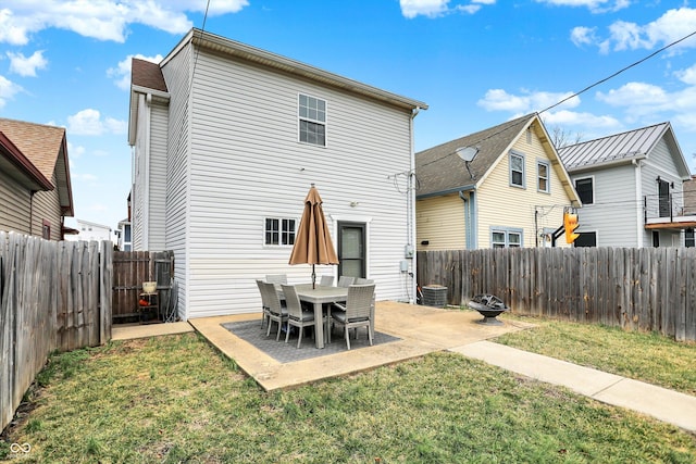 rear view of property with a patio area, a lawn, and a fenced backyard