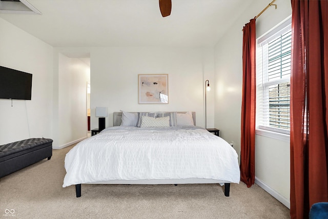 bedroom with ceiling fan, baseboards, and light carpet