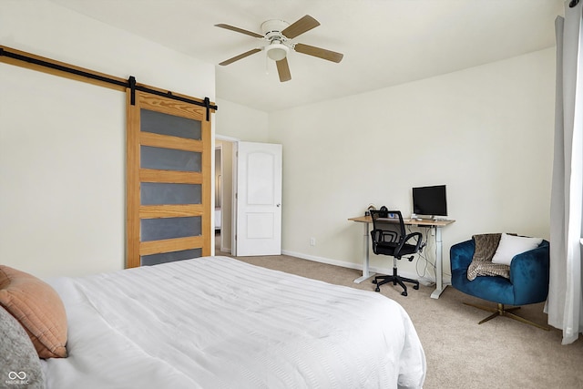 carpeted bedroom with baseboards, lofted ceiling, a barn door, and a ceiling fan