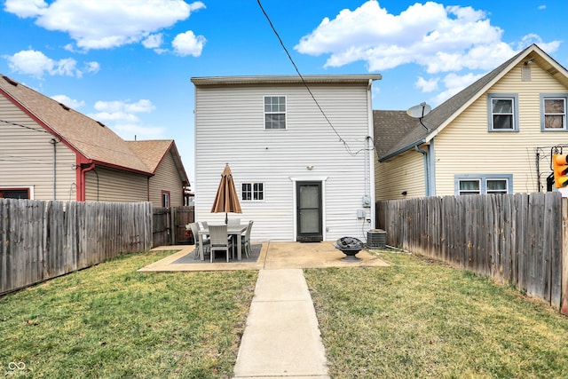 back of house with a patio, a lawn, and a fenced backyard