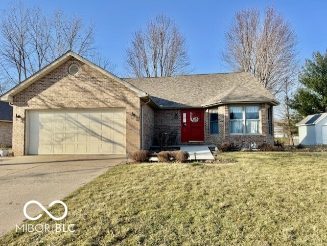 ranch-style home featuring a front yard, driveway, an attached garage, a shingled roof, and brick siding