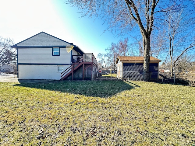 back of house with stairway, fence, and a lawn