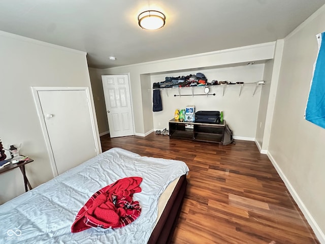 bedroom featuring baseboards and wood finished floors