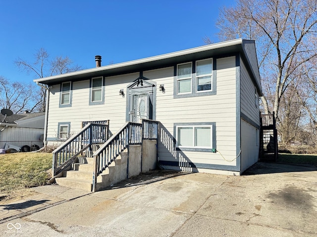 bi-level home with concrete driveway