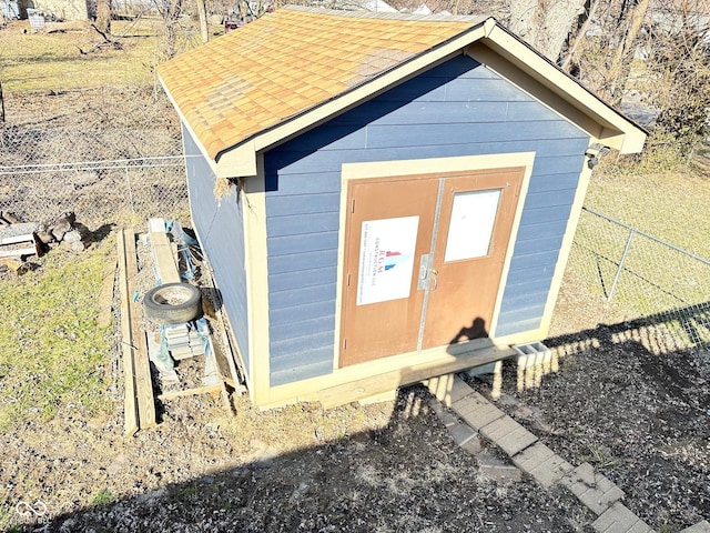 view of outbuilding featuring an outbuilding and fence