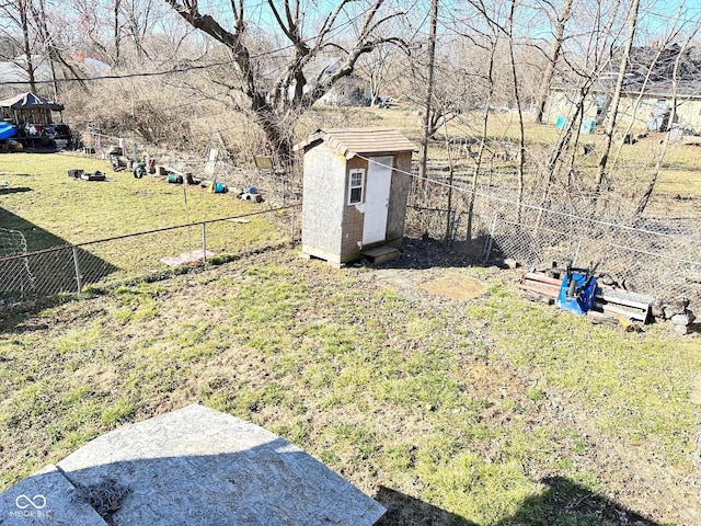 view of yard with an outbuilding, a storage shed, and fence