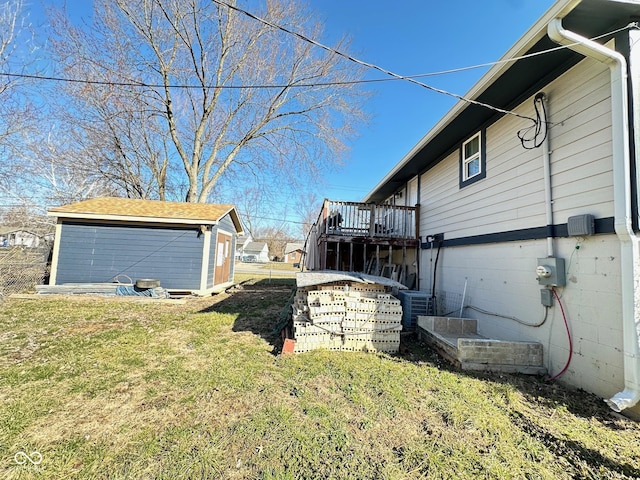 view of yard with stairway, central AC, an outdoor structure, and fence