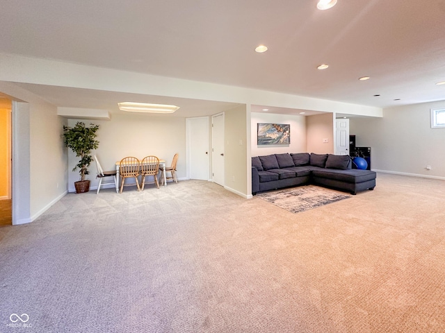 living room featuring recessed lighting, baseboards, and light colored carpet