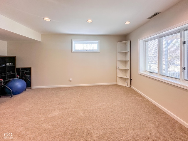 workout area featuring light carpet, visible vents, recessed lighting, and baseboards