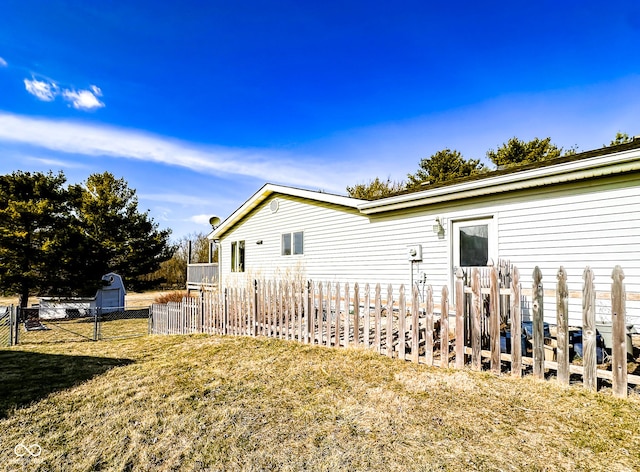 view of property exterior featuring a yard and fence