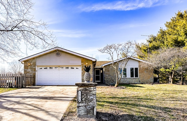 ranch-style home with fence, driveway, a front lawn, stone siding, and a garage