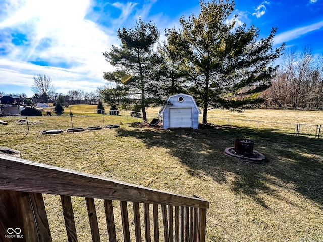 view of yard featuring an outdoor structure, a storage unit, and fence