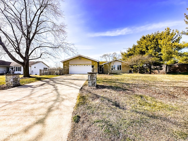 ranch-style house with a front lawn, an attached garage, driveway, and fence