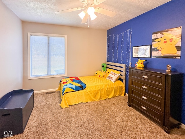 carpeted bedroom featuring visible vents, ceiling fan, a textured ceiling, and baseboards