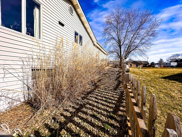 view of home's exterior featuring fence