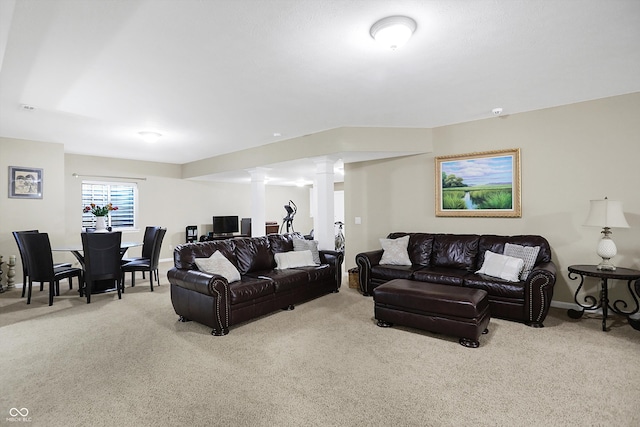 carpeted living room with baseboards and ornate columns