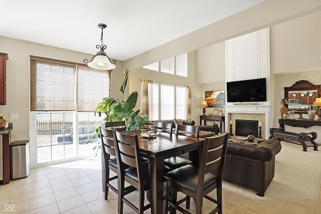 dining room featuring light tile patterned flooring and a fireplace