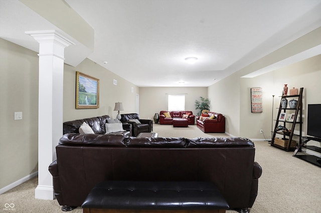 carpeted living area featuring decorative columns and baseboards