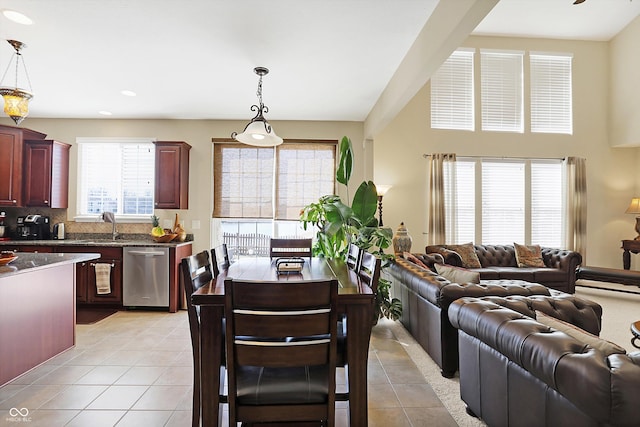 kitchen featuring light tile patterned floors, reddish brown cabinets, dishwasher, and open floor plan