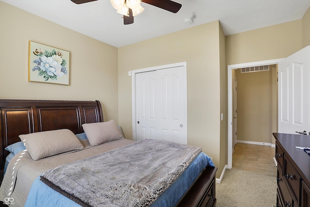 bedroom with light tile patterned floors, a ceiling fan, baseboards, visible vents, and a closet