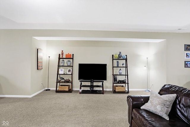 living area featuring carpet and baseboards