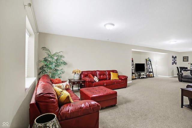 carpeted living room with baseboards