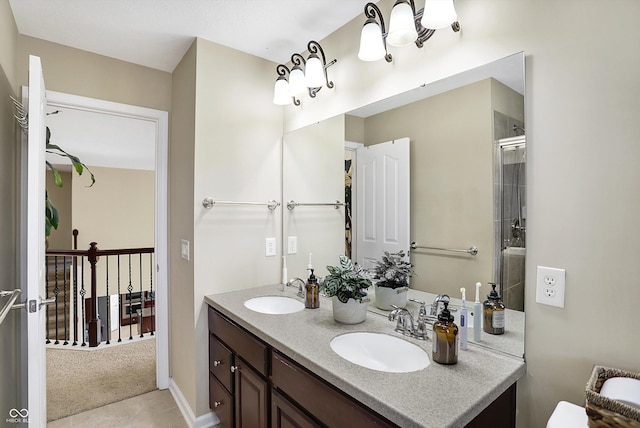 full bathroom with double vanity, an enclosed shower, and a sink