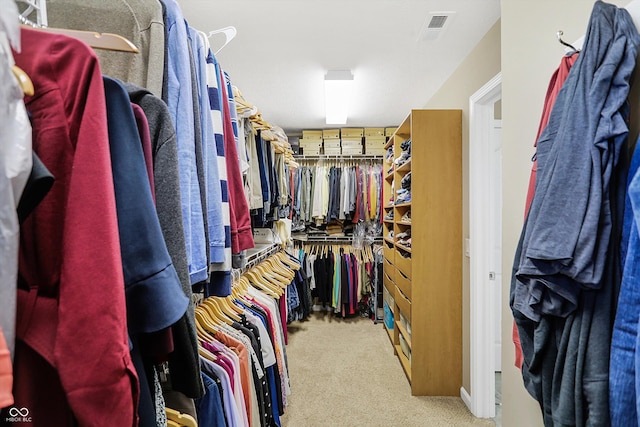 walk in closet with visible vents and carpet