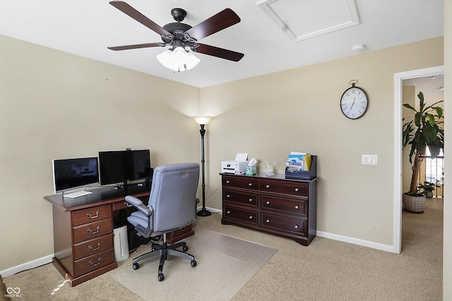 home office with baseboards, light carpet, attic access, and ceiling fan