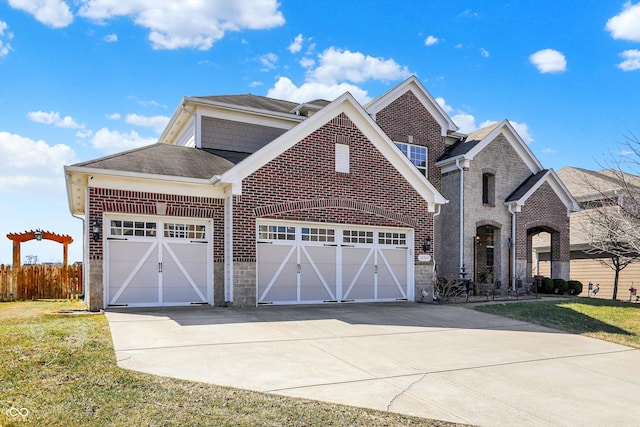 view of front of property featuring a front yard, an attached garage, brick siding, and driveway