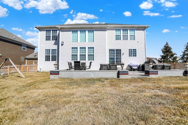 back of house with a patio, a lawn, and fence