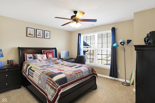 bedroom with visible vents, baseboards, light colored carpet, and ceiling fan