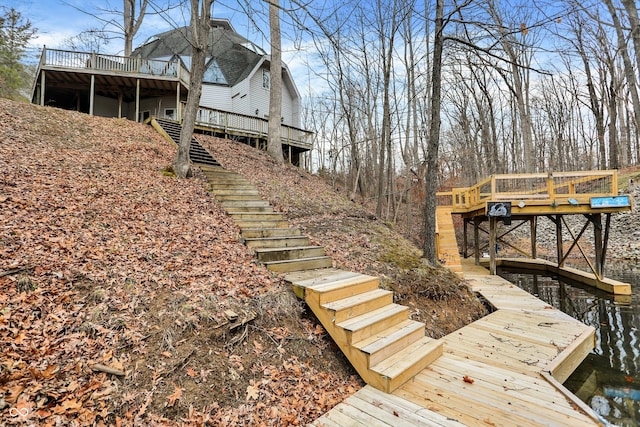 view of dock with stairway and a deck