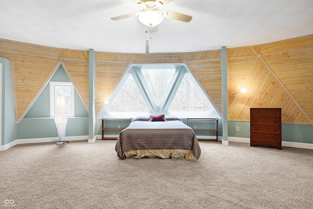 bedroom with vaulted ceiling, wood walls, and carpet floors