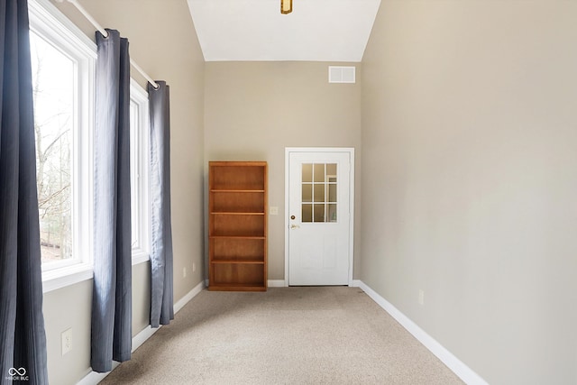 interior space with visible vents, baseboards, and lofted ceiling