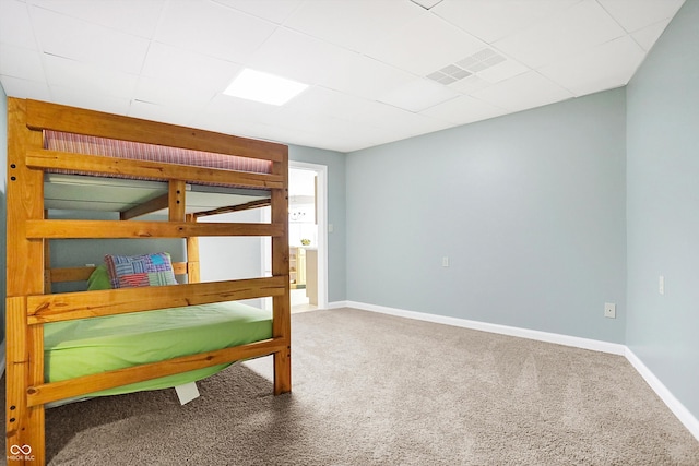 carpeted bedroom featuring visible vents and baseboards