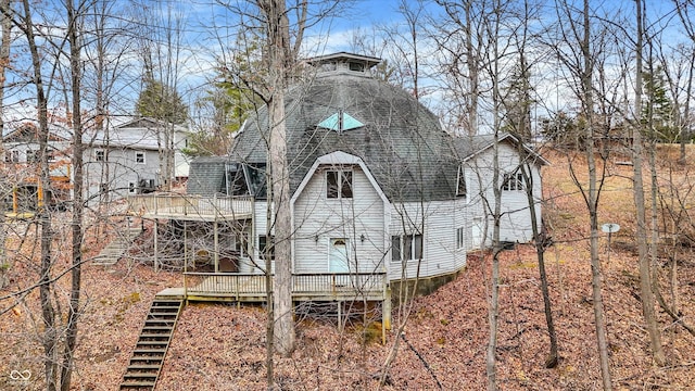 back of property featuring a wooden deck, stairway, and a shingled roof