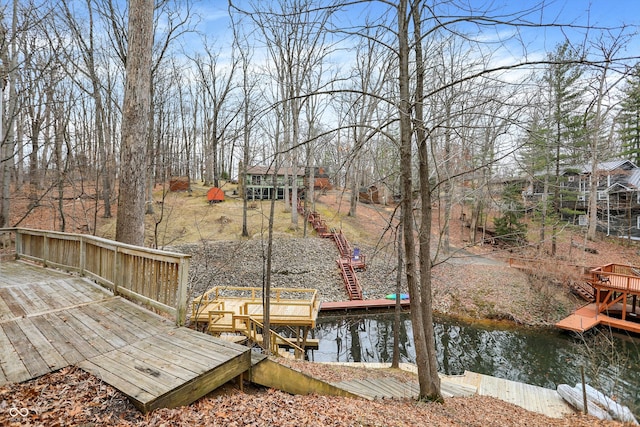 dock area with stairs and a deck with water view