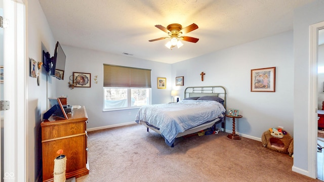 carpeted bedroom featuring visible vents, baseboards, and ceiling fan