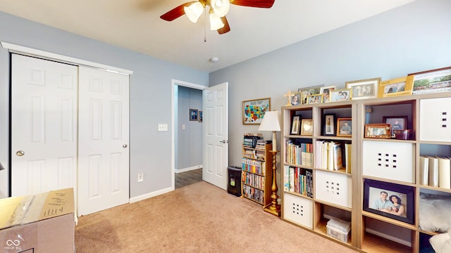 interior space featuring baseboards, carpet, and a ceiling fan