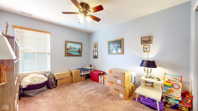 game room with visible vents, carpet floors, and ceiling fan