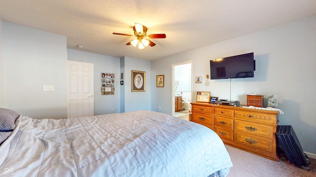 bedroom featuring ensuite bathroom, a ceiling fan, and carpet flooring