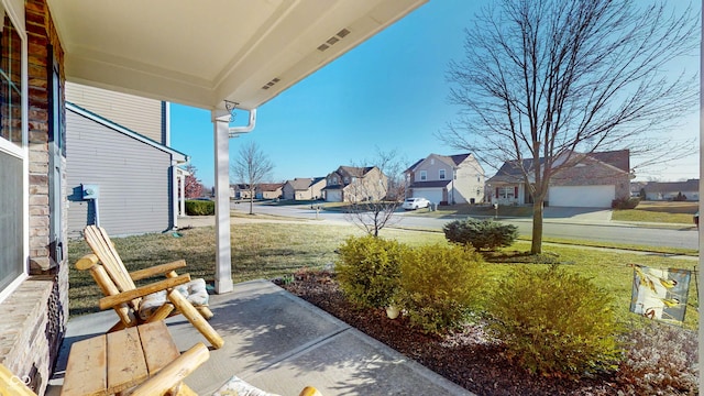 view of yard with a residential view and a porch