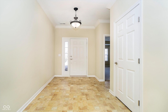 foyer entrance featuring visible vents, baseboards, and ornamental molding