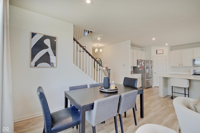 dining space with recessed lighting, light wood-type flooring, stairs, and baseboards