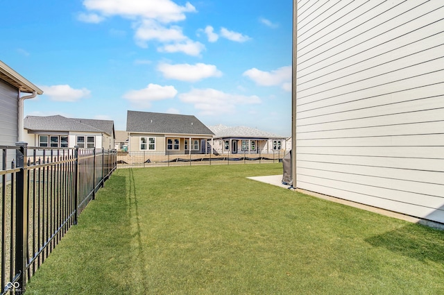 view of yard with a residential view and a fenced backyard