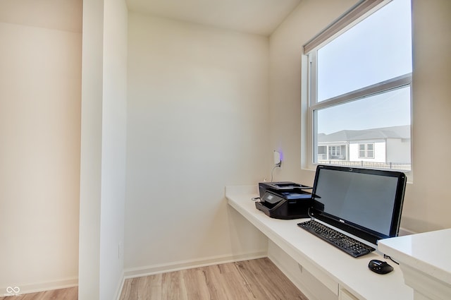 home office featuring light wood-type flooring and baseboards